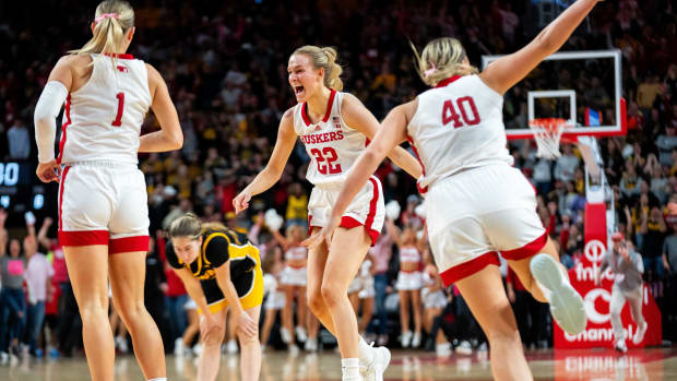 Nebraska's Natalie Potts runs to her teammates after defeating Iowa 82-79 Sunday, Feb. 11, 2024, at Pinnacle Bank Arena.